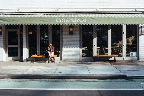 cafe woman sitting in front of the store restaurant